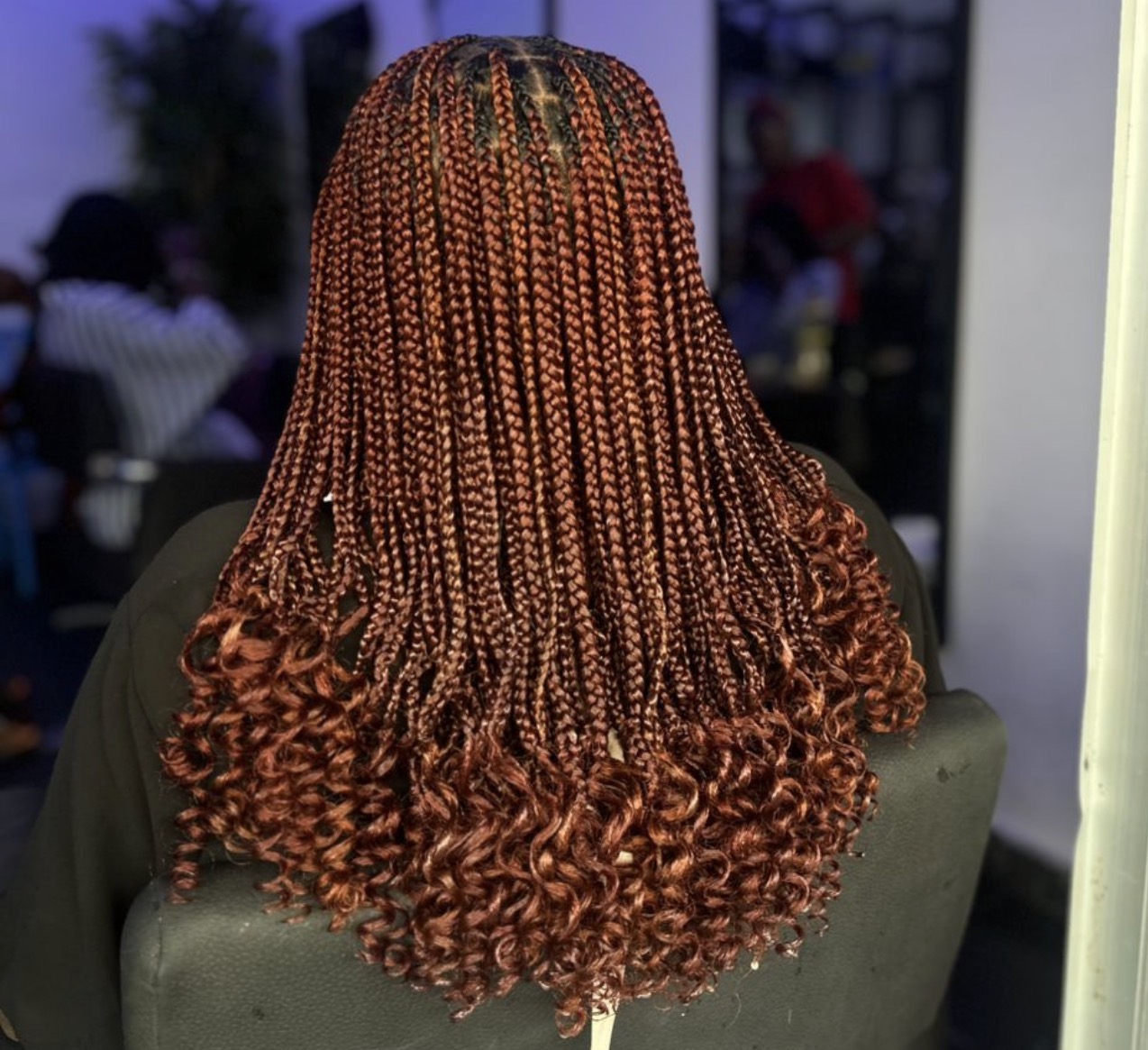 Auburn box braids with curly tips
